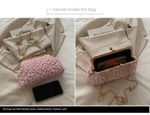 Detail of pink floral pearl evening bag showing interior capacity and dimensions next to phone