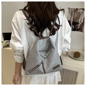 Detail of chevron woven fabric and brown leather shoulder strap on the summer tote bag