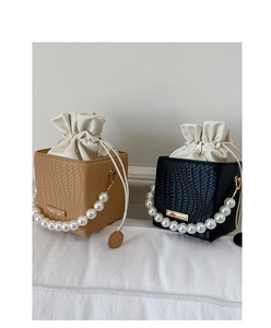 Close-up of woven bucket bags with faux pearl handles and drawstring inner lining