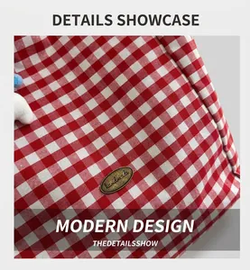 Detailed macro view of the red and white gingham fabric texture and handmade metal label