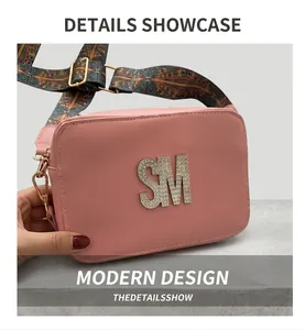 Detailed shot of pink leather bag with rhinestone SM logo and ethnic woven shoulder strap