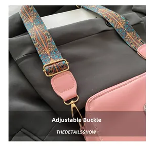 Detailed view of pink leather crossbody bag with bohemian woven strap and gold buckles
