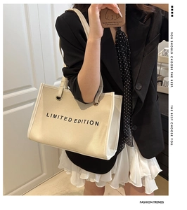 Detail of cream canvas tote bag with black Limited Edition print for daily style