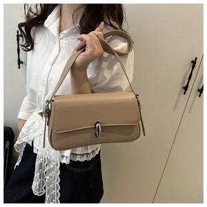 Detail of khaki leather shoulder bag with sleek silver capsule clasp and wide strap