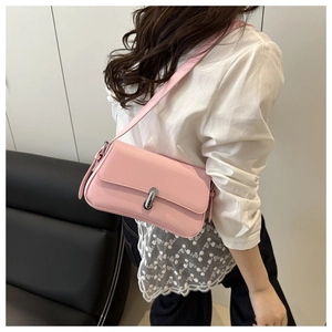 Detailed side view of a pink rectangular leather shoulder bag with a silver swivel lock