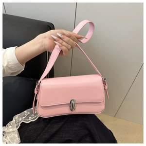 Detail of light pink baguette bag showing matte leather texture and silver twist lock