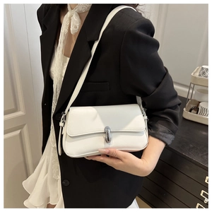 Close-up of white PU leather underarm bag with silver metal buckle on a shoulder strap