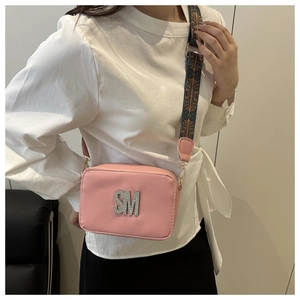 Pink PU leather crossbody bag featuring a silver rhinestone SM logo and patterned strap