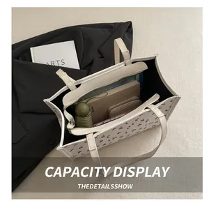 Internal view of cherry print tote bag showing storage for umbrella and notebook
