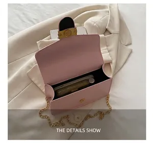 Internal view of pink flap chain bag showing capacity for phone and wallet