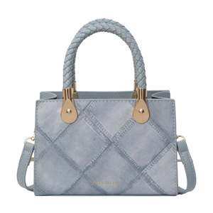 Light blue quilted mini tote bag with woven handles and gold hardware details