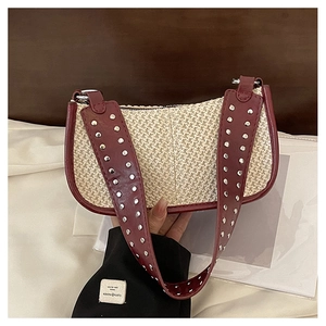 Chic woven underarm bag in cream straw with burgundy studded wide strap and contrast trim