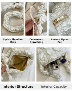 Detailed close-up of quilted cloud bag showing drawstring, metal zipper, and interior pocket