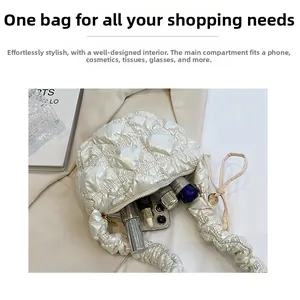 Detailed interior view of white quilted puff bag showing capacity for phone and cosmetics