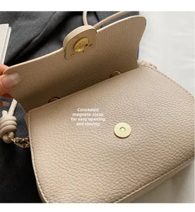 Vue détaillée du cuir grainé et du fermoir magnétique invisible sur le sac beige de selle
