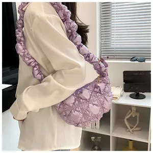 Detail view of light purple quilted cloud bag with pleated bubble texture and ruffled strap