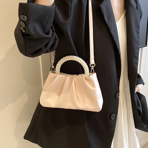 Borsa a nuvola plissettata rosa chiaro con manico di perle e tracolla su modella