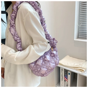 Detail of lavender quilted cloud bag with pleated shoulder strap and silk texture