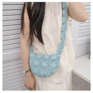 Stylish light blue quilted bubble cloud bag with a wide padded shoulder strap for women