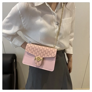 Detailed close-up of pink leather crossbody bag featuring gold M logo and chain strap