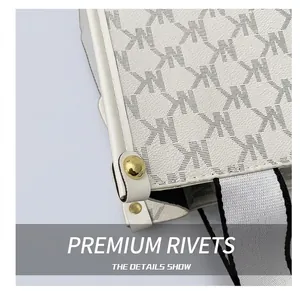 Detailed macro view of monogram pattern on white leather with gold stud and woven strap