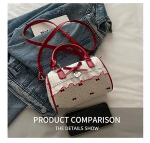 Detail of sweet polka dot Boston bag featuring red bows, lace trim, and heart charm