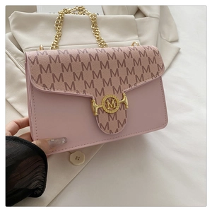 Detail of light pink shoulder bag with M pattern print and gold M metal buckle closure