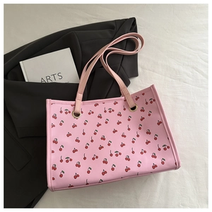 Detail of floral tote bag with pink cherry print and durable golden metal eyelets