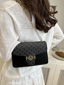 Fashionable contrast color shoulder bag with gold chain and M monogram flap in white room