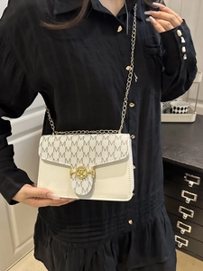 Chic cream contrast color crossbody bag with M logo pattern and golden chain strap