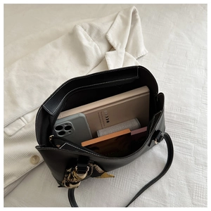 Internal view of black leather tote bag showing large capacity for daily essentials