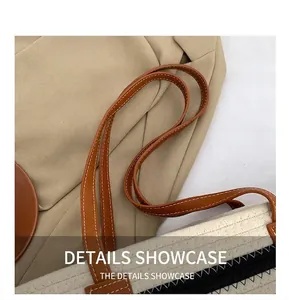 Macro detail of the woven cotton bag featuring brown leather handle and fine white stitching