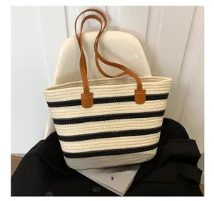 Close-up detail of the woven cotton rope texture and striped pattern on the tote bag