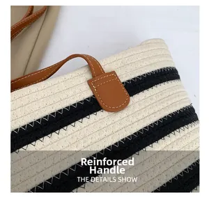 Detail view of reinforced brown leather handle and black-white striped woven cotton tote