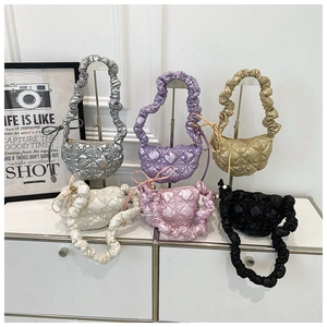 Detailed display of six colorful quilted bubble bags with pleated handles in a minimalist setup