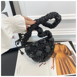 Detail of black cloud bag with quilted bubble texture and ruffled scrunchie handle