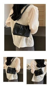 Detail view of the black ruched PU leather shoulder bag featuring a unique thick strap