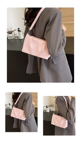 Detail of pink pleated crossbody bag showing soft leather texture and elegant shoulder strap