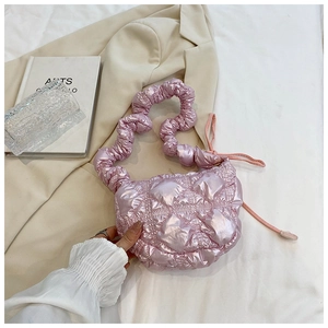 Detail of pink quilted bubble bag with glossy finish and ruched shoulder strap texture