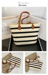 Detail of woven cotton tote bag with beige stripes and premium brown leather handles