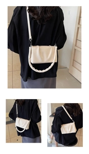 Detail view of the creamy white pleated cloud bag showing soft faux leather and versatile straps