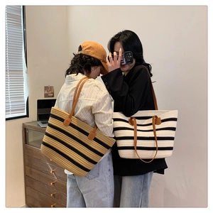 Two models wearing striped woven cotton tote bags for beach or daily commute use