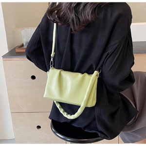 Detail view of avocado green pleated crossbody bag with matching ruched handle strap