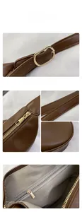 Detailed view of the dark brown PU leather bag with golden hardware and precision stitching