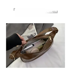 Brown PU leather dumpling bag detail showing large capacity with daily essentials inside