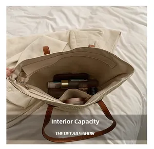 Macro view showing the large internal capacity of the straw tote bag with brown straps