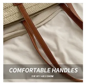 Detail of cream straw woven tote with brown leather handle and white contrast stitching