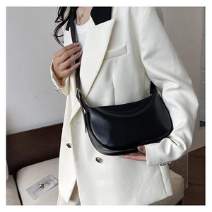 Fashionable black PU leather hobo bag worn by model with adjustable shoulder strap