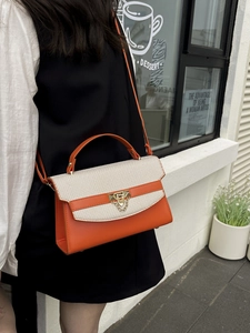 Classic orange and cream patchwork crossbody handbag with textured flap and gold clasp
