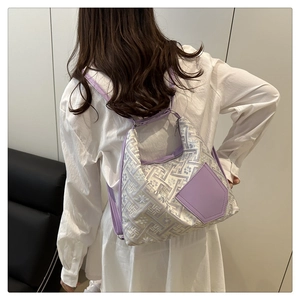 Detail of lavender floral jacquard shoulder bag with elegant geometric weaving texture